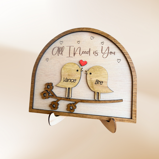 Wooden laser cut love birds ornament on a stand with the wording All I Need is You and you can personalise with 2 names