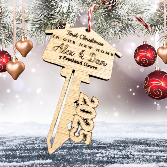 Wooden laser cut key with engraved wording of First Christmas in our New Home with personalised names and address for 2025