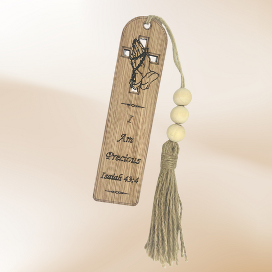Wooden Bookmark with the wording "I am Precious Isaiah 43:4" with praying hands graphic over a cut out cross.  Finished with jute tassel and white beads.