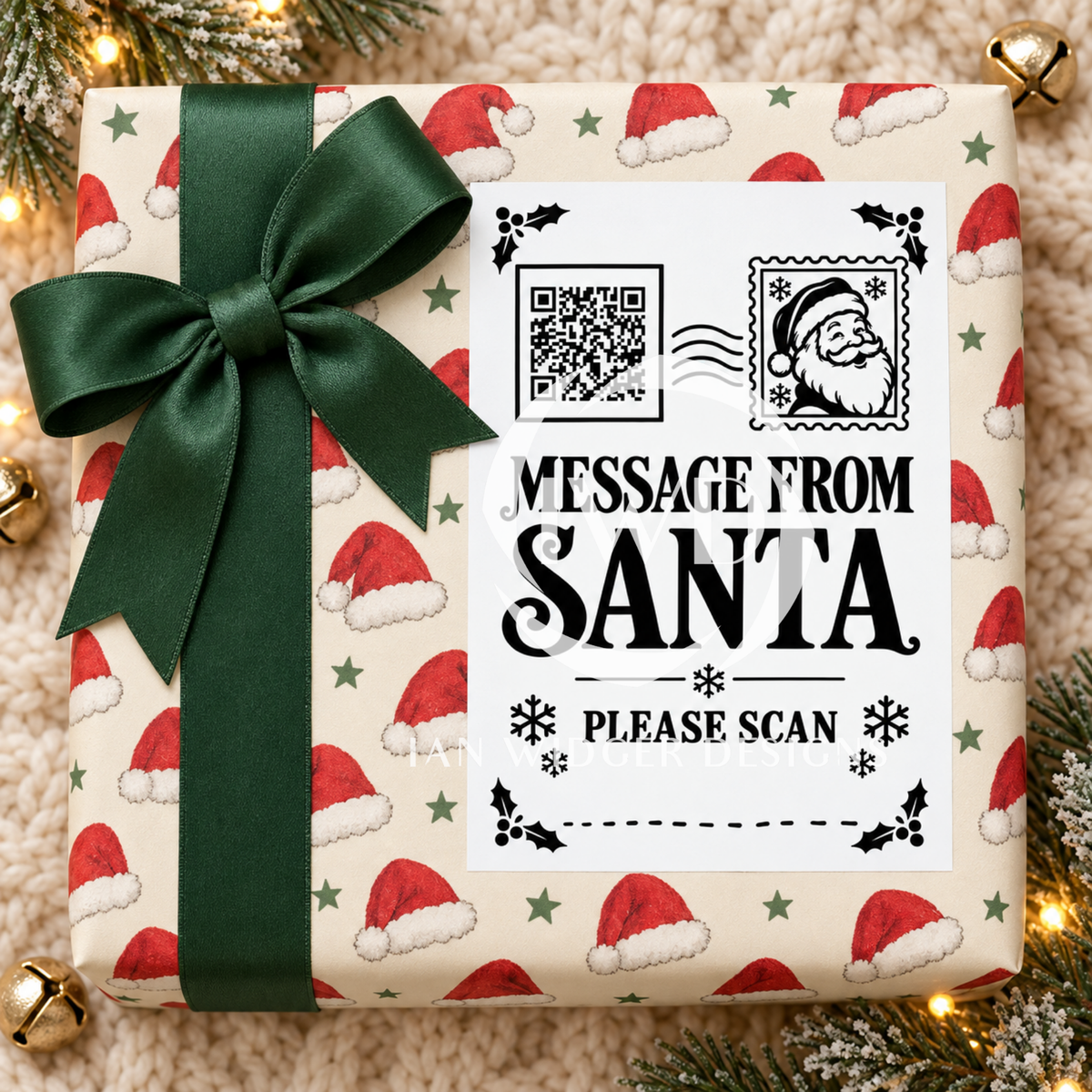 A Christmas-themed gift box wrapped in festive Santa hat patterned paper with a large dark green ribbon bow. The front features a white insert card with a QR code, Santa illustration, and the text 'MESSAGE FROM SANTA PLEASE SCAN'.